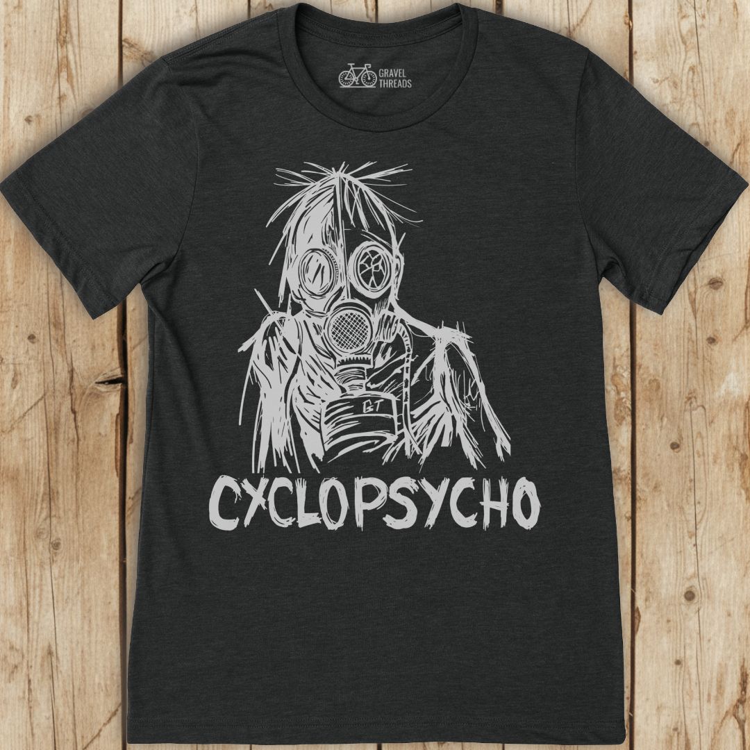 Black t-shirt with white graphic design and 'Cyclopsycho' text on a wooden surface