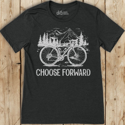 Black t-shirt with a bicycle graphic and 'Choose Forward' text on a wooden surface