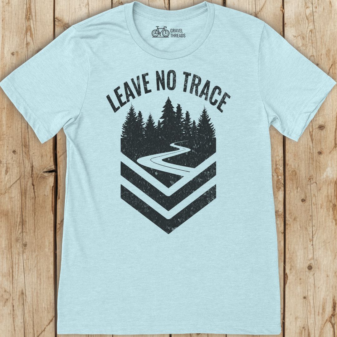 Light blue t-shirt with 'Leave No Trace' graphic on a wooden surface
