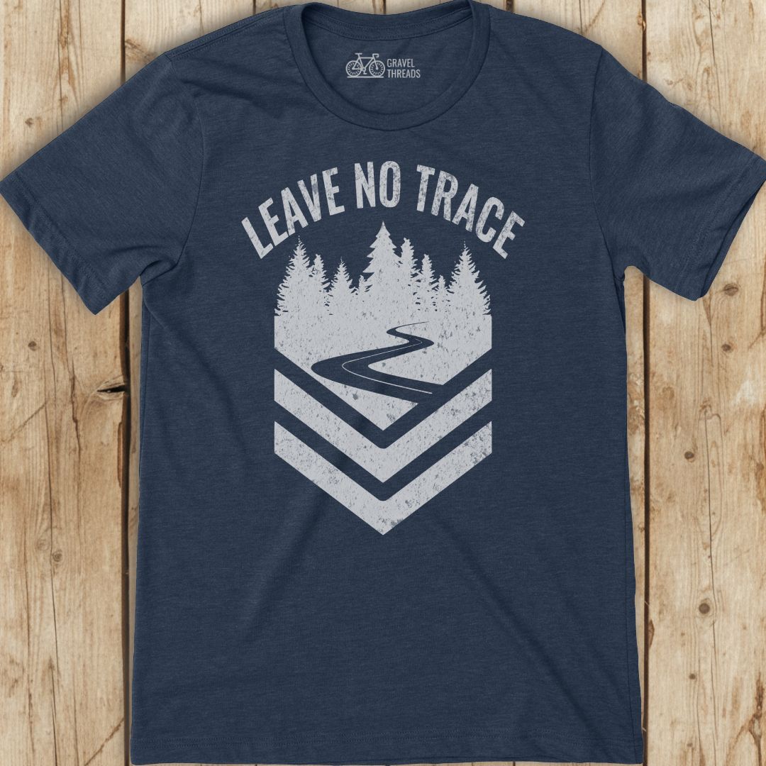 Navy blue t-shirt with 'Leave No Trace' graphic on a wooden surface