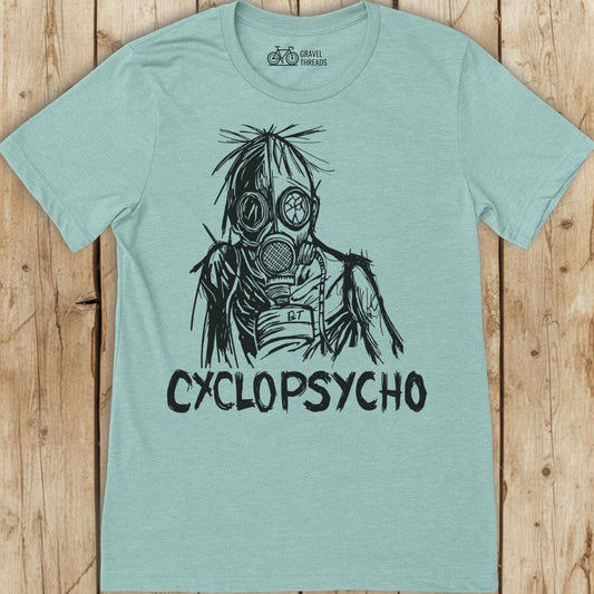 Light blue t-shirt with a graphic design and 'Cyclopsycho' text on a wooden surface